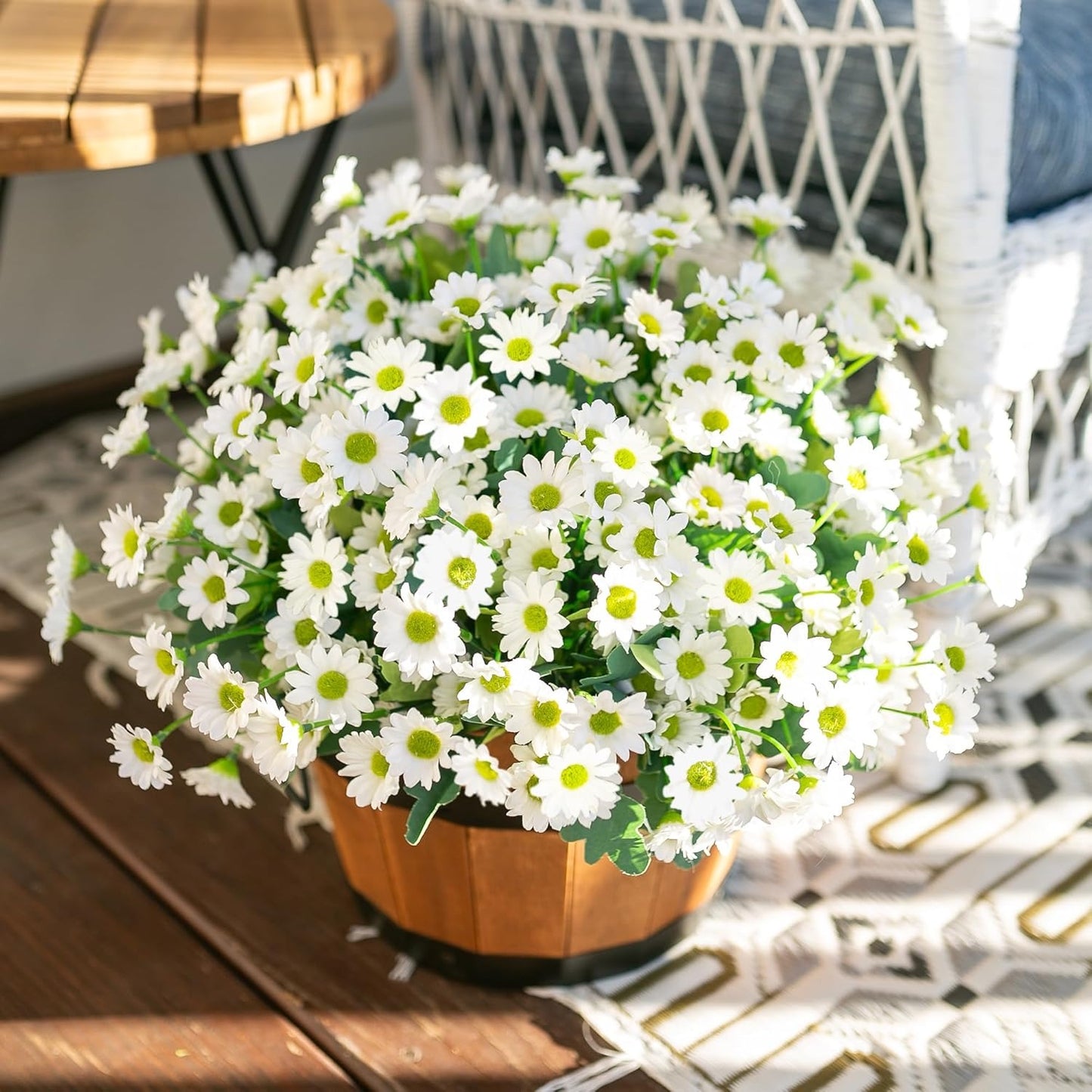 Potted plant with white flowers on a wooden table