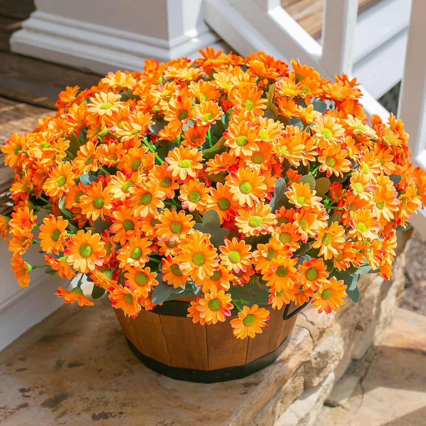 Potted plant with orange flowers on a stone surface