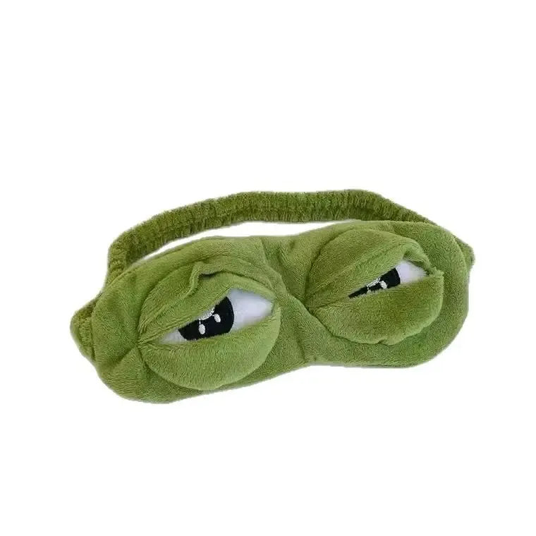 Frog Sleep Mask — A stylish, shimmering sleep mask featuring an adorable "Sad Frog" design. This fun, plush eye mask is perfect for travel, yoga, napping, and light-blocking; its soft cotton lining gently cares for sensitive skin.