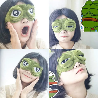 Frog Sleep Mask — A stylish, shimmering sleep mask featuring an adorable "Sad Frog" design. This fun, plush eye mask is perfect for travel, yoga, napping, and light-blocking; its soft cotton lining gently cares for sensitive skin.