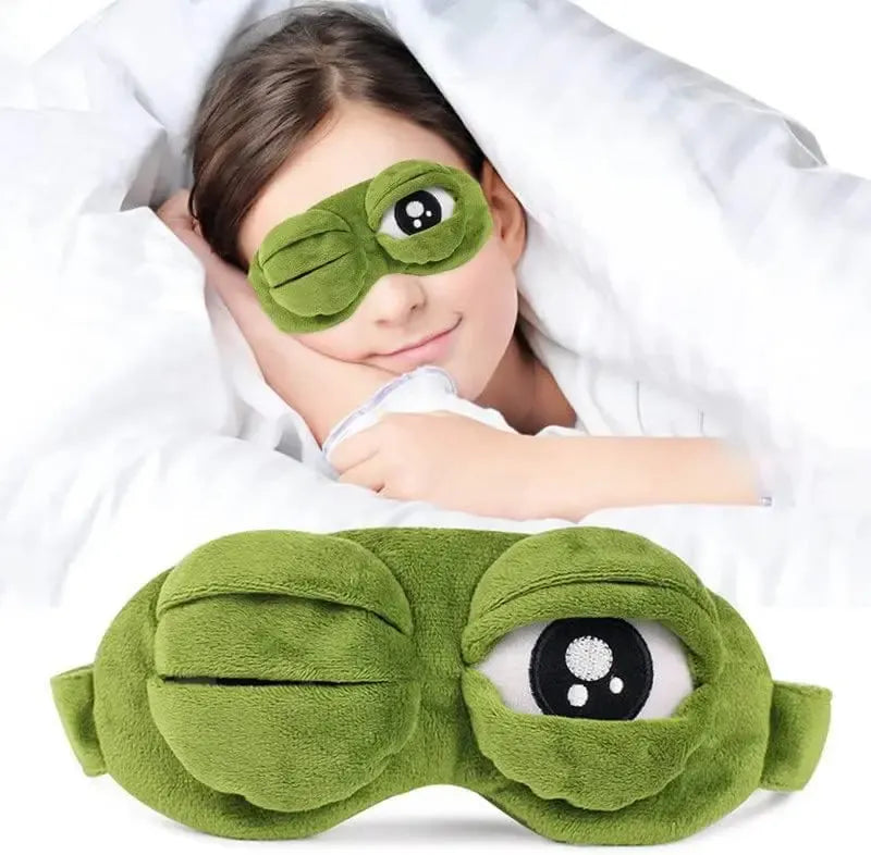 Frog Sleep Mask — A stylish, shimmering sleep mask featuring an adorable "Sad Frog" design. This fun, plush eye mask is perfect for travel, yoga, napping, and light-blocking; its soft cotton lining gently cares for sensitive skin.
