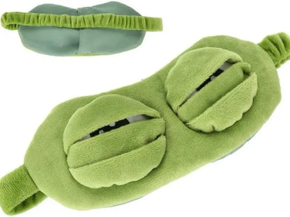 Frog Sleep Mask — A stylish, shimmering sleep mask featuring an adorable "Sad Frog" design. This fun, plush eye mask is perfect for travel, yoga, napping, and light-blocking; its soft cotton lining gently cares for sensitive skin.