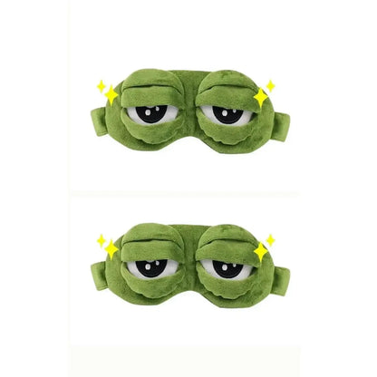 Frog Sleep Mask — A stylish, shimmering sleep mask featuring an adorable "Sad Frog" design. This fun, plush eye mask is perfect for travel, yoga, napping, and light-blocking; its soft cotton lining gently cares for sensitive skin.