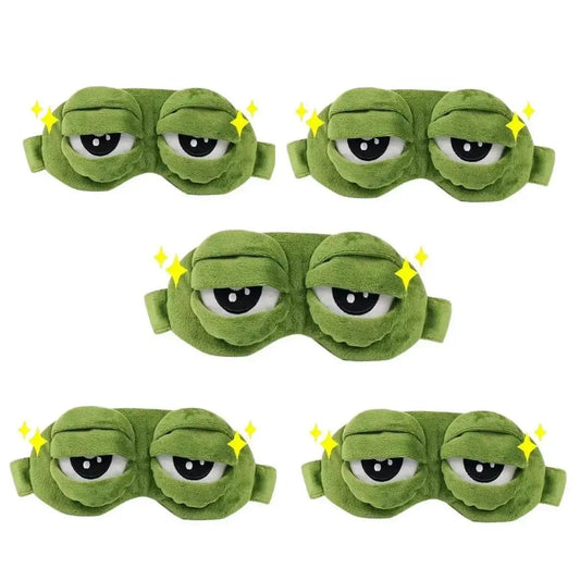 Frog Sleep Mask — A stylish, shimmering sleep mask featuring an adorable "Sad Frog" design. This fun, plush eye mask is perfect for travel, yoga, napping, and light-blocking; its soft cotton lining gently cares for sensitive skin.