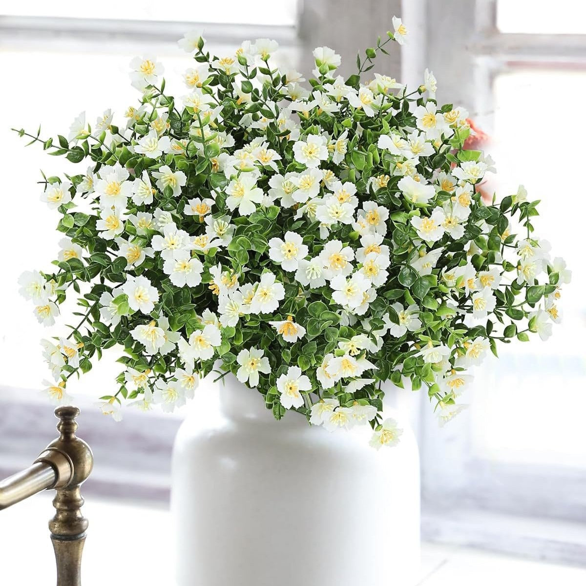 White flowers in a white vase on a blurred background