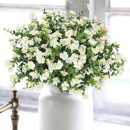 White flowers in a white vase on a blurred background