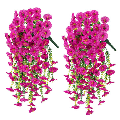 Two pink hanging floral arrangements on a white background