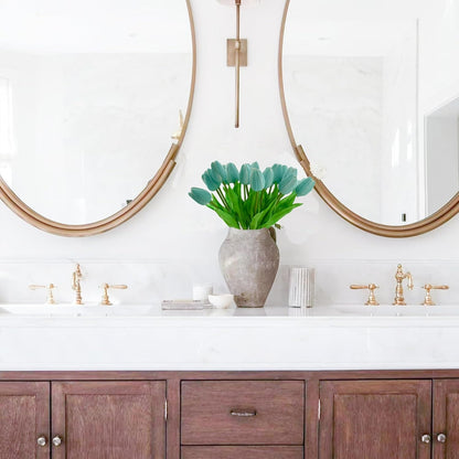 Bathroom vanity with wooden cabinets, white countertop, and decorative elements.